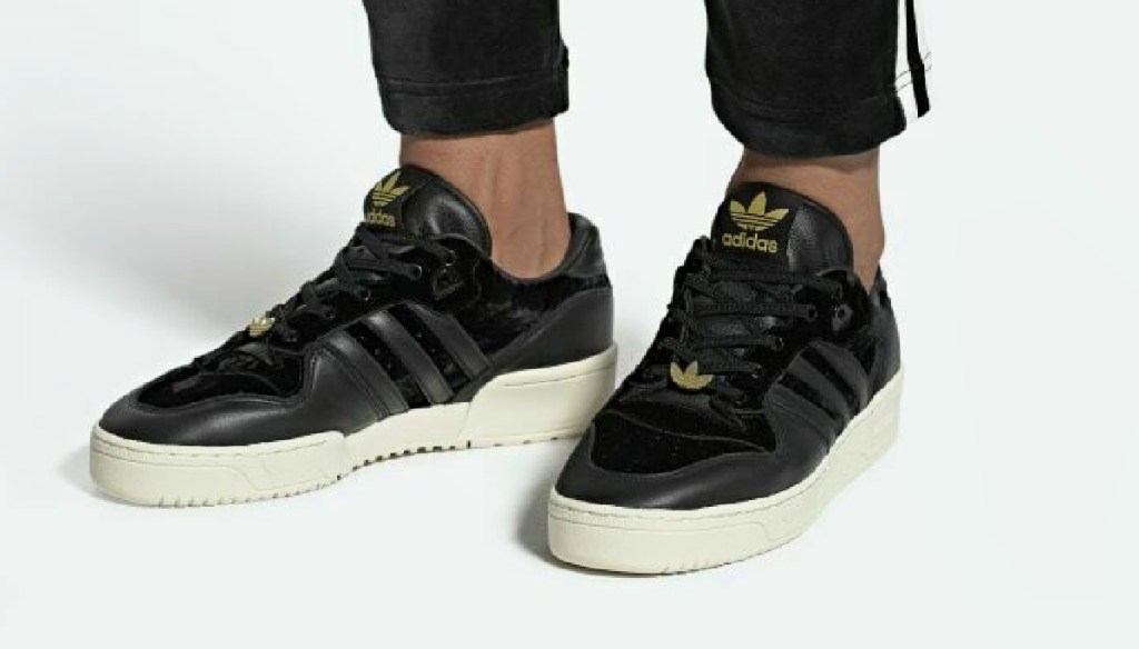 Man wearing Adidas Men's Originals Rivalry Low Shoes