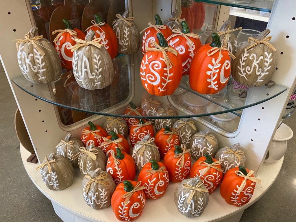 two shelves of Monogram Pumpkins