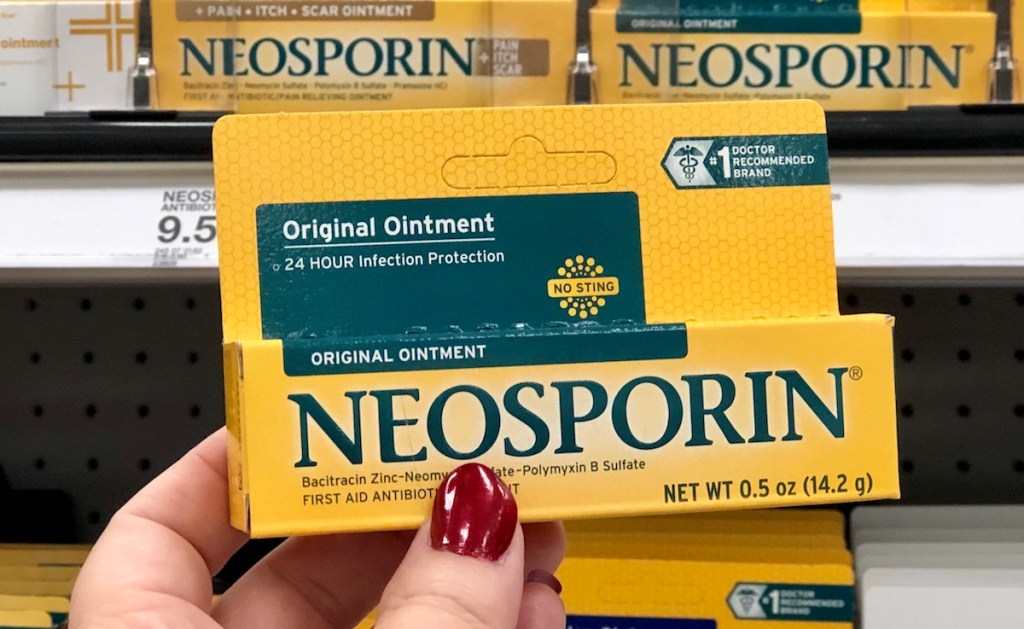 hand holding Neosporin box