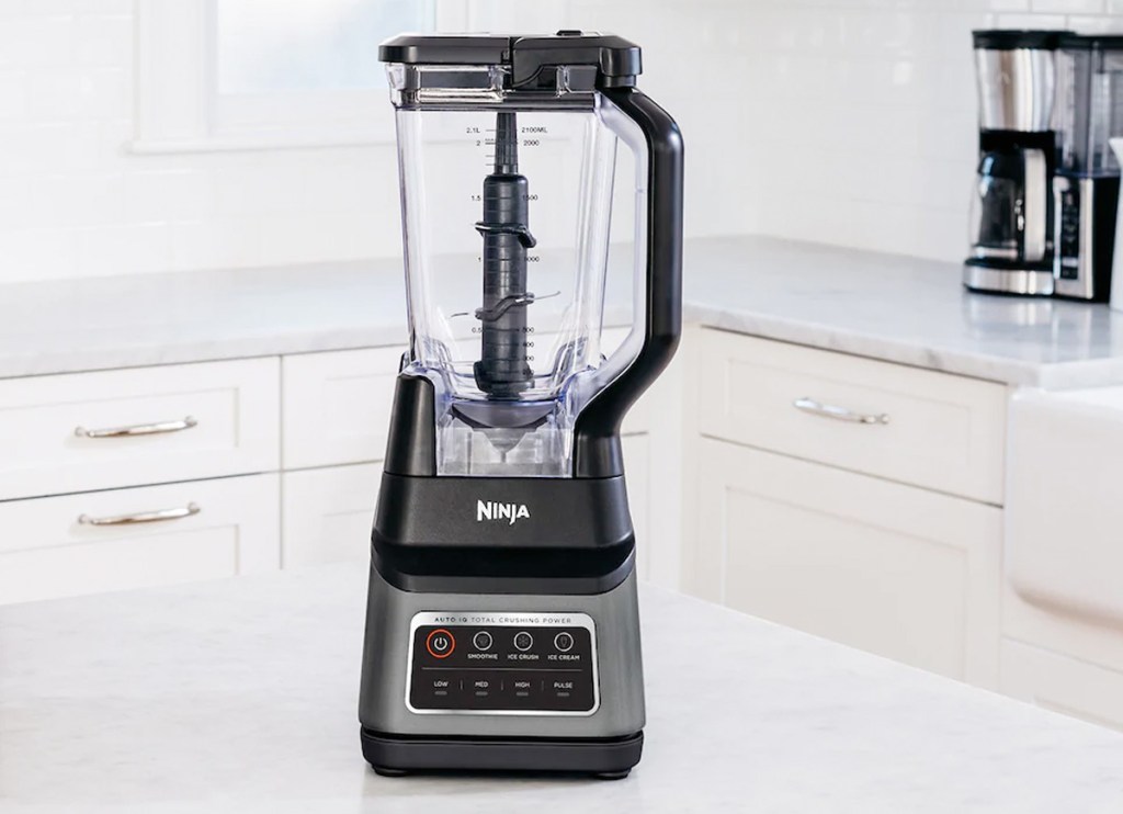 stainless steel and black ninja blender sitting on white kitchen countertop