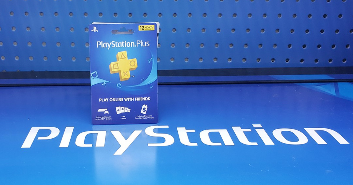 playstation plus gift card sitting on top of a blue playstation sign