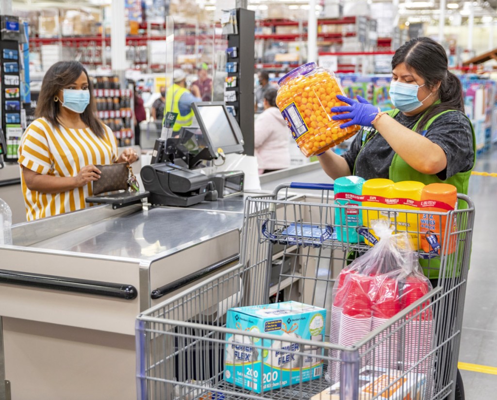 customer and cashier at sam's club wearing face masks at checkstand