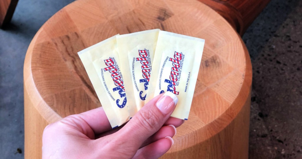 Splenda packets in person's hand