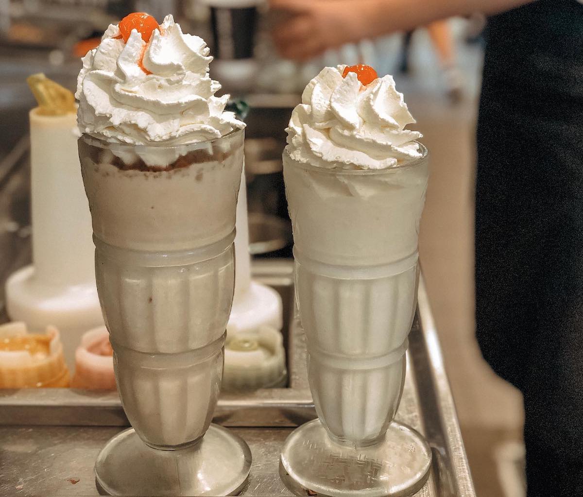 two milkshakes in glass cups at steak n shake