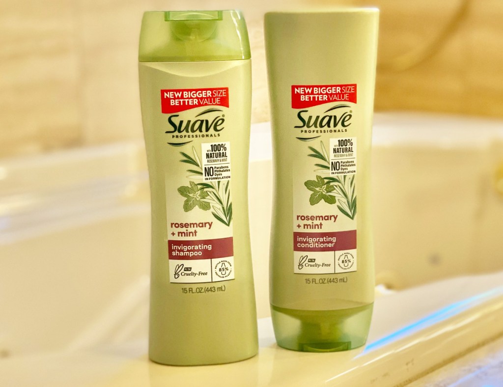 two green bottles of suave professionals shampoo and conditioner sitting on edge of tub