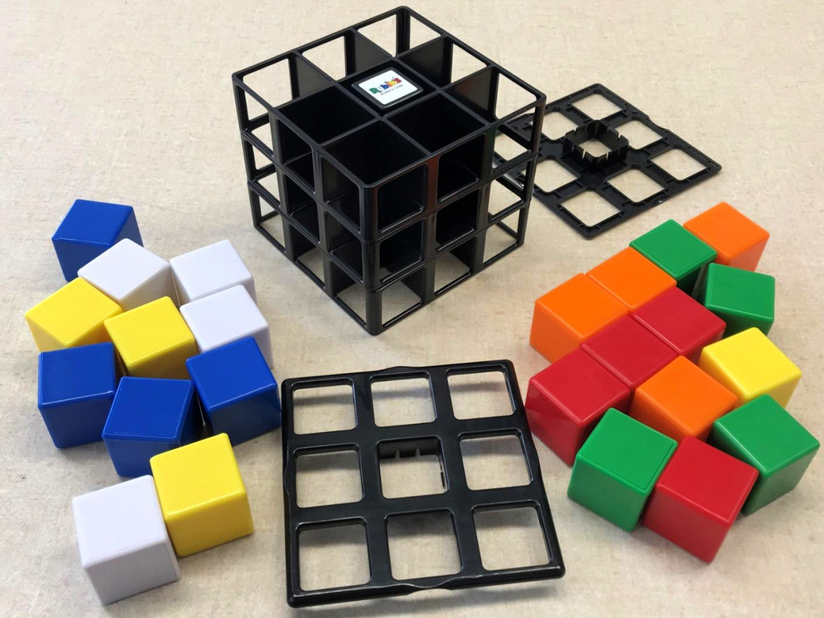 kid playing with a University Games Rubik's Cage Game