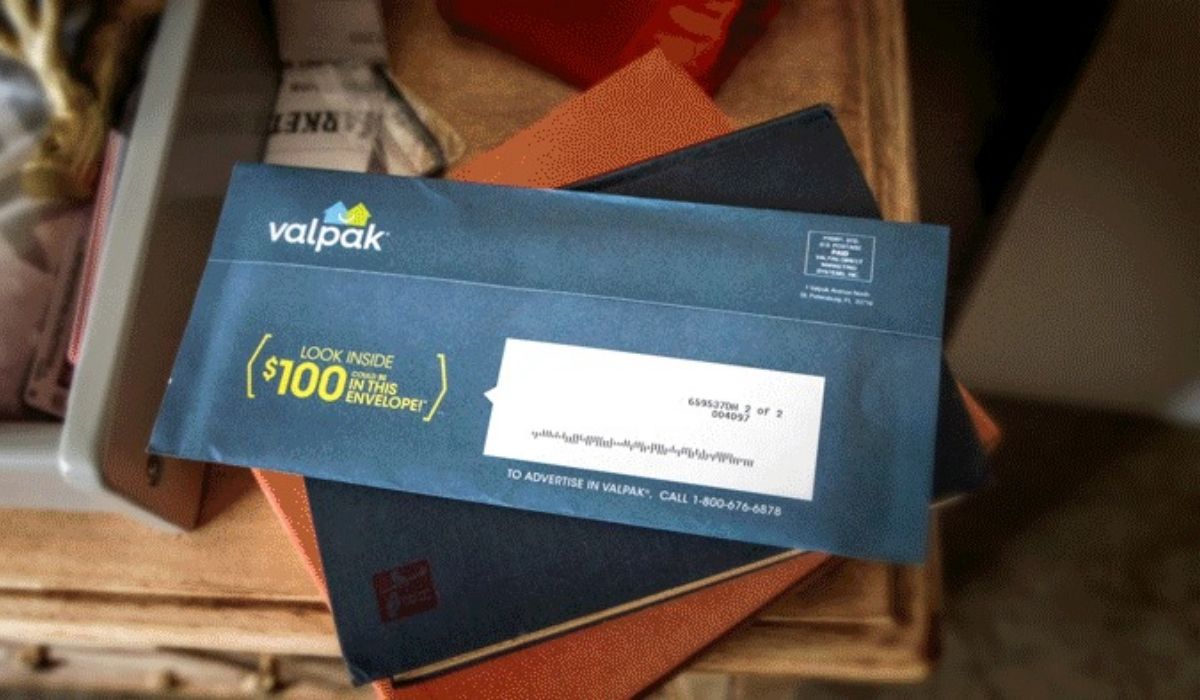 A valpak envelope on top of books