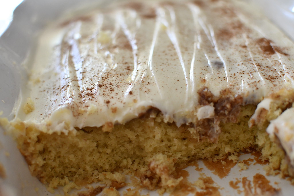 cinnamon roll poke cake in casserole dish 