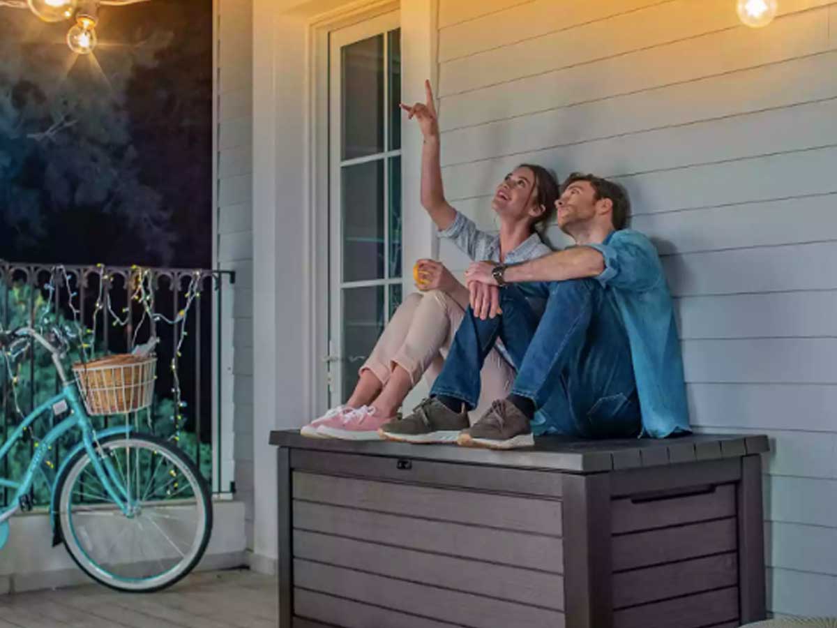 couple sitting on outdoor deck box