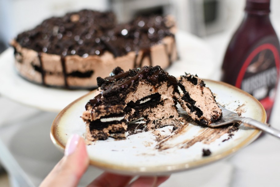 cutting into a slice of oreo cake