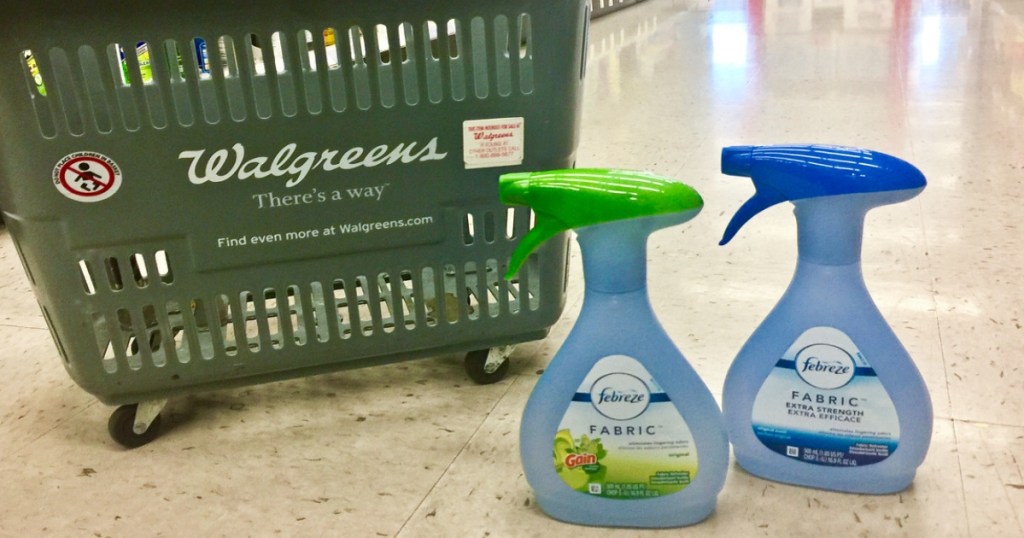 two bottles of Air freshener at walgreens on the floor in front of a walgreens basket