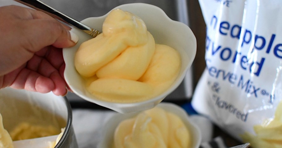 woman's hand holding a bowl of frozen dole whip