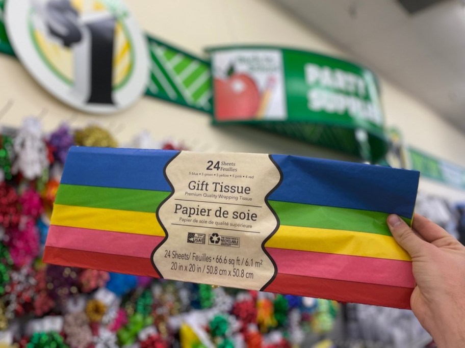 hand holding up colorful tissue paper at Dollar Tree