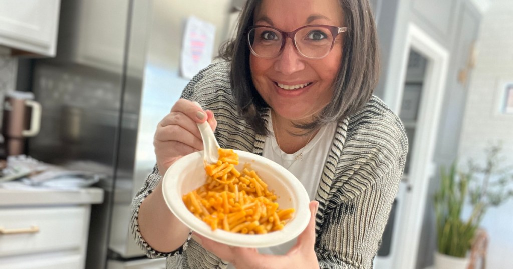 holding a bowl of mac and cheese