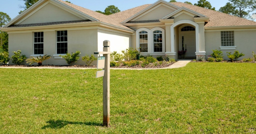 home with for sale sign in front yard 