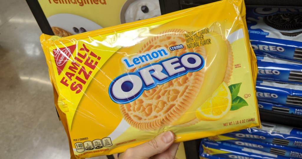 hand holding package of lemon cookies by store display