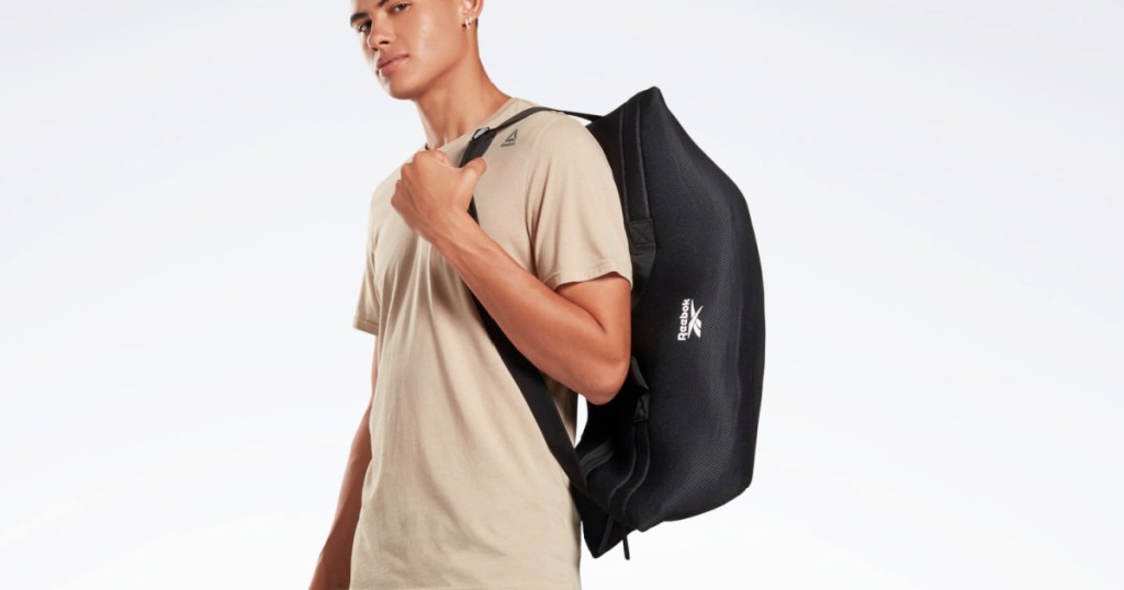 man holding a Reebok Training Supply Bag