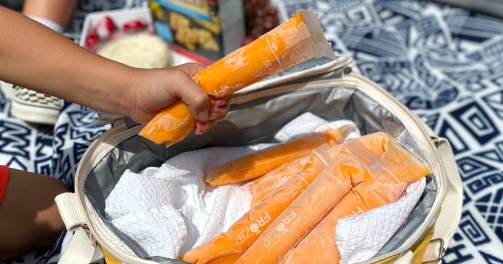 child holding orange push-up popsicle 