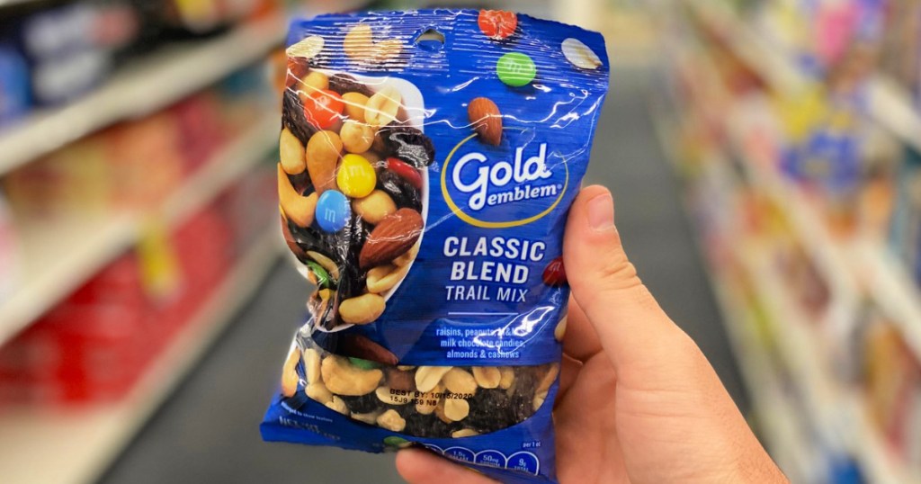 person holding a bag of gold emblem classic blend trail mix