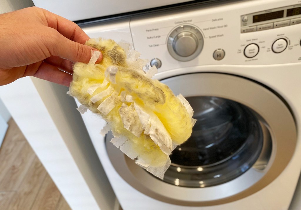 dirty swiffer duster in front of washing machine