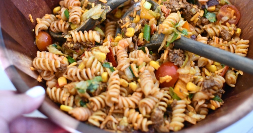 close up of taco pasta salad in wood bowl