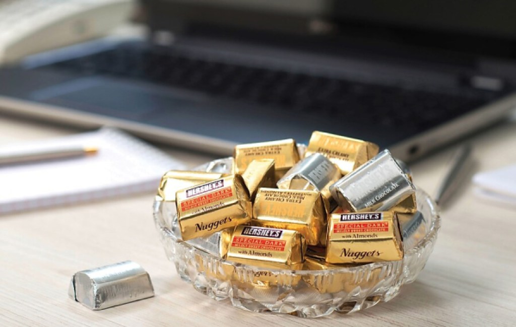 hersheys nugget chocolate in bowl next to desk