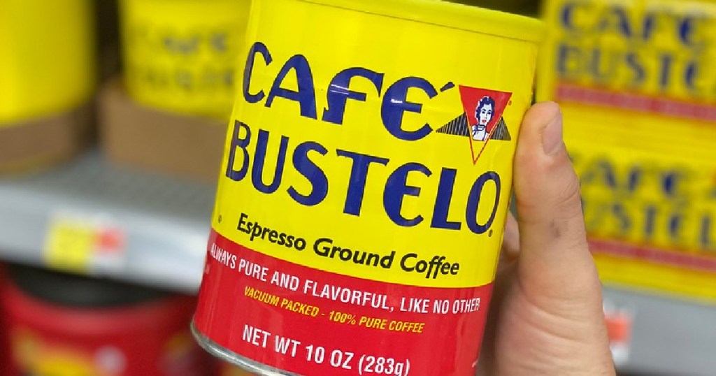 hand holding can of ground coffee in store