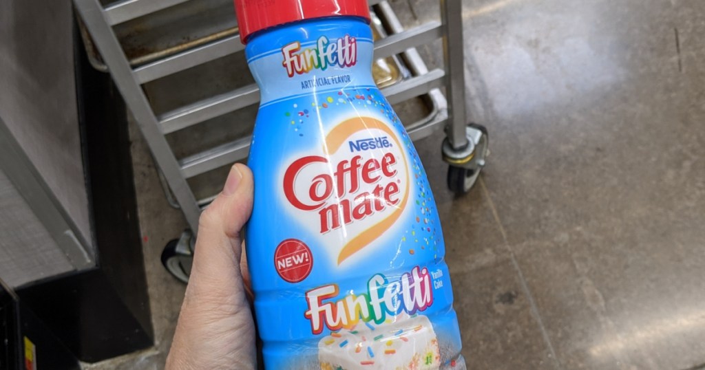 Hand holding Funfetti Coffee-Mate Creamer in store