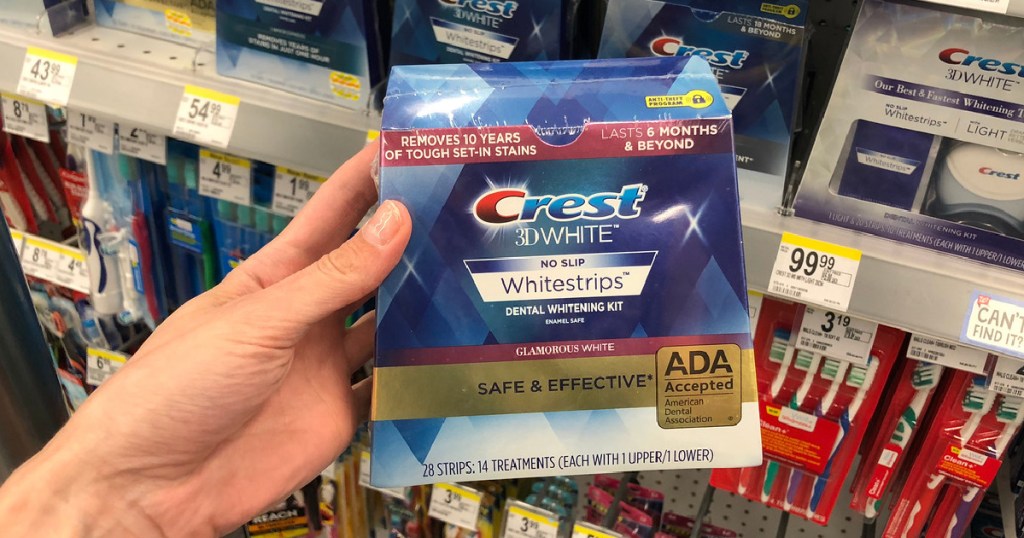 hand holding box of teeth whitening strips in store