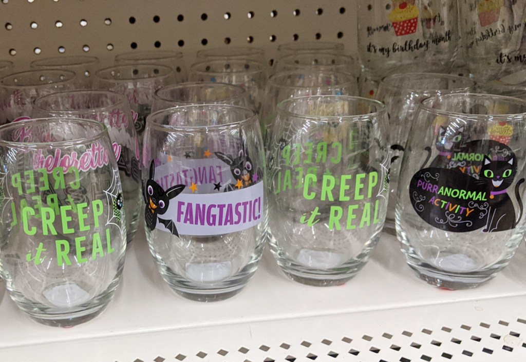 store shelf with stemless wine glasses with halloween prints on them