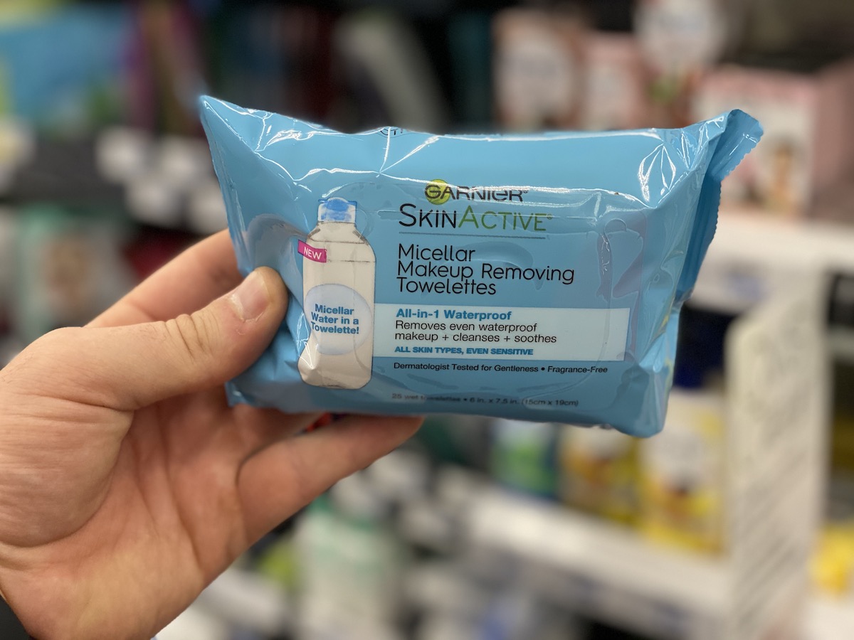 hand holding blue pack of Garnier Skinactive Micellar Makeup Removing Towelettes at CVS