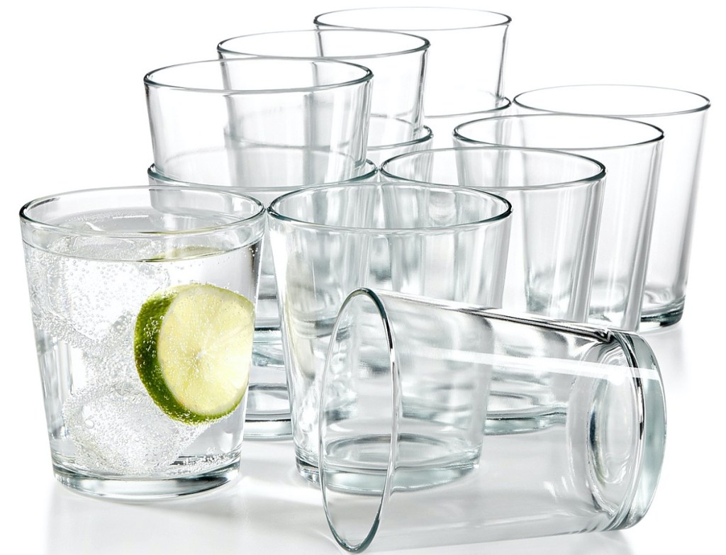 twelve small tumblers, one filled with water and lime