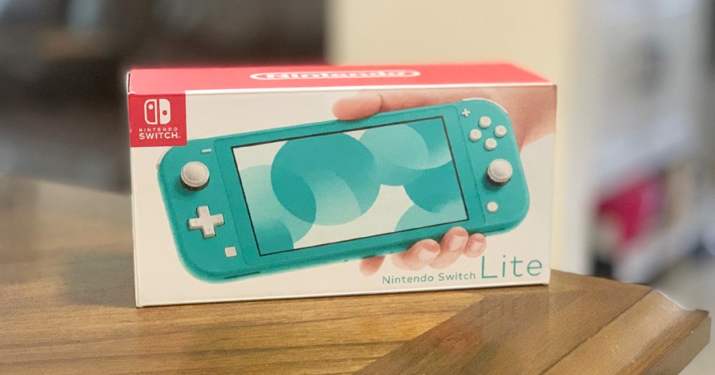 box for a blue nintendo switch lite on a wood table