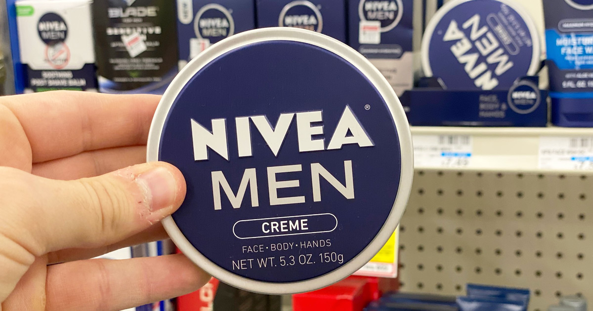 man holding up a blue colored round tin of Nivea Men's face and body creme