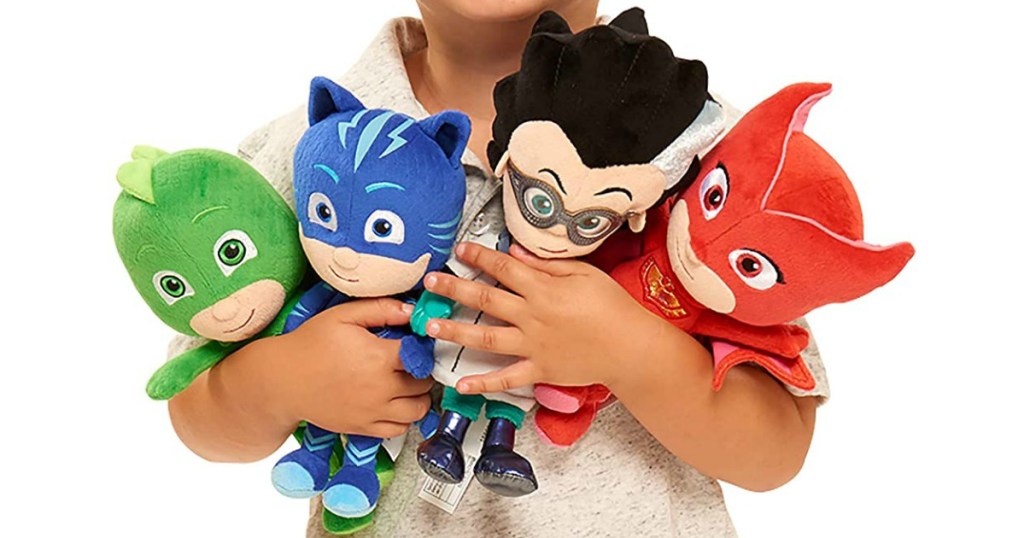 child holding PJ Masks plush toys