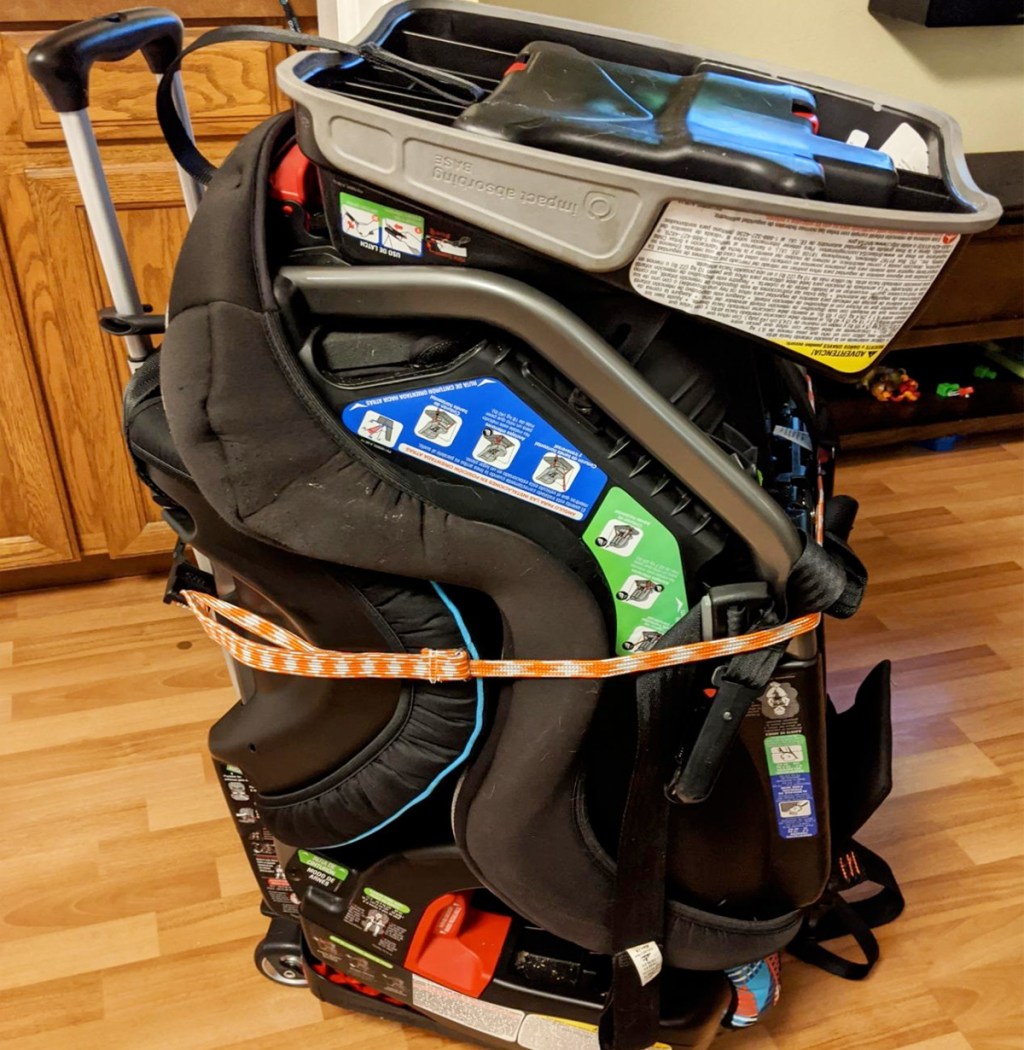 luggage cart with two kids car seats attached to it