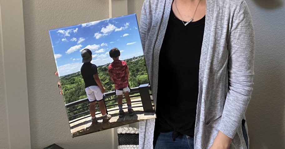 woman standing in an entryway holding an 8x10 simple canvas print