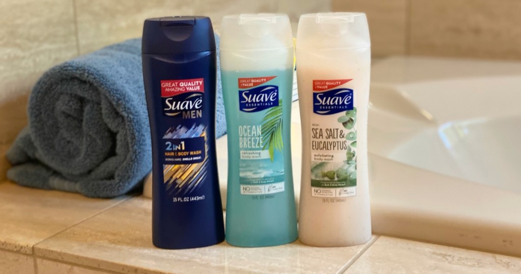 3 bottles of Suave body wash on the bathtub shelf