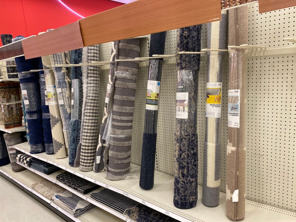 multiple Target Room Essentials Rugs on shelf at target