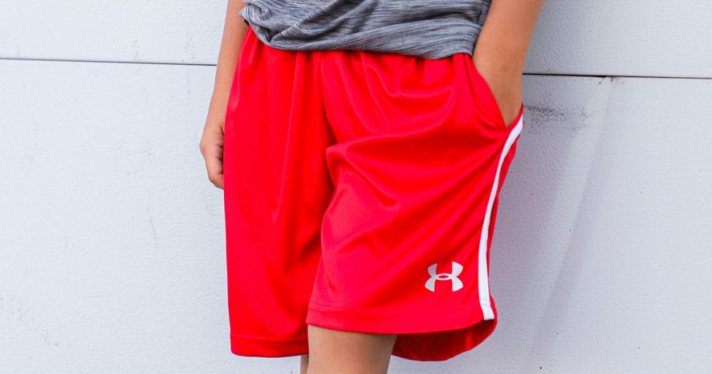 boy wearing red shorts