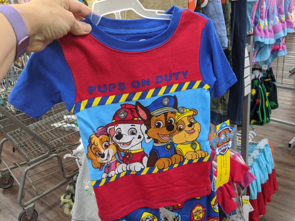 hand holding toddler paw patrol pajama set in store