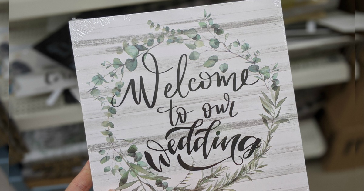 hand holding Wedding Sign from Dollar Tree