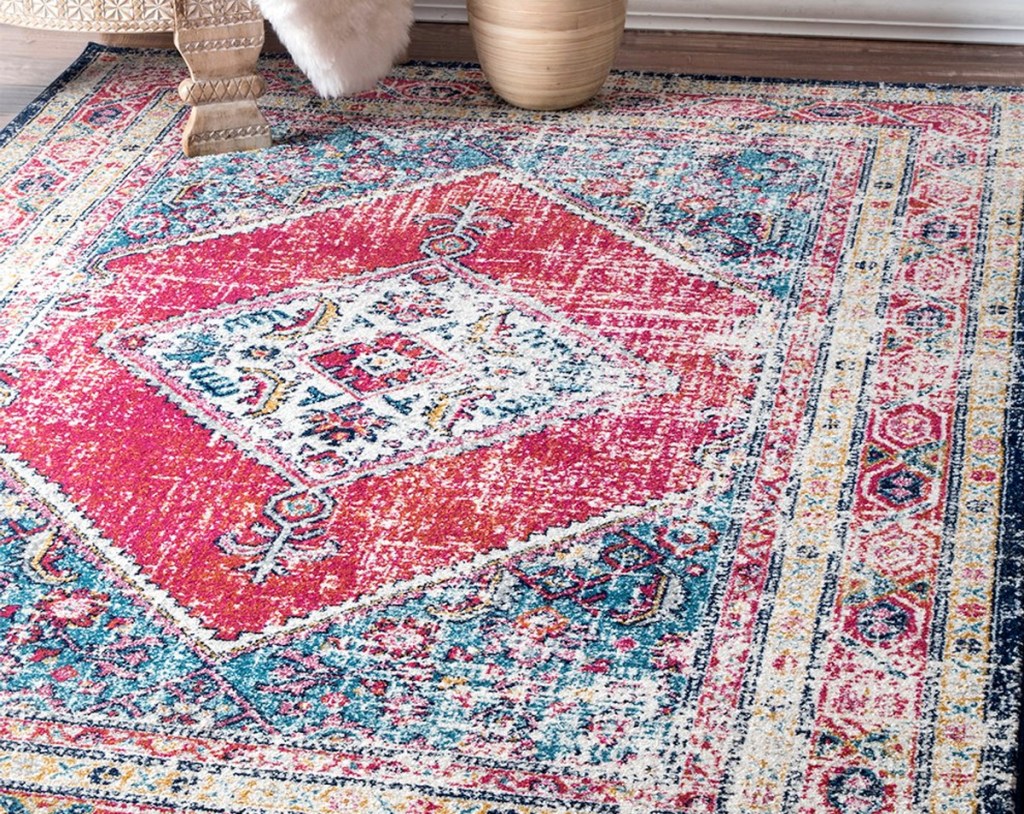 blue and red medallion print area rug on hardwood floor