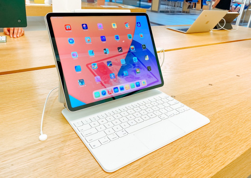 apple ipad with keyboard sitting on wood table in store