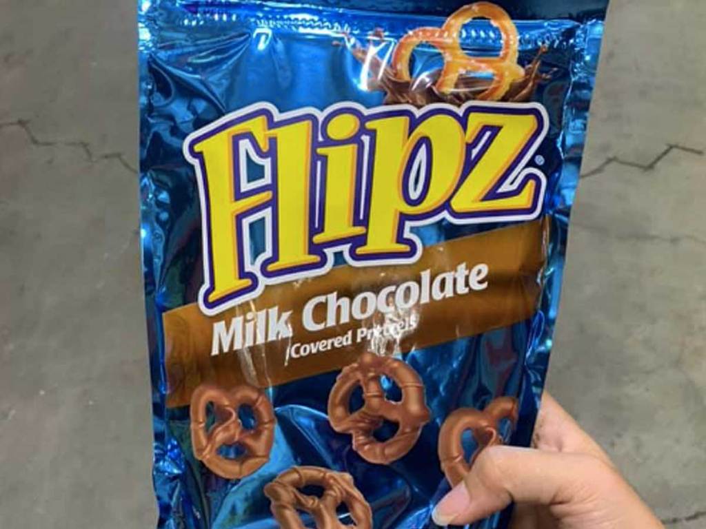 hand holding bag of chocolate pretzels