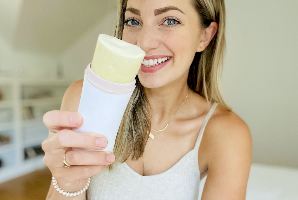 woman holding stick of deodorant