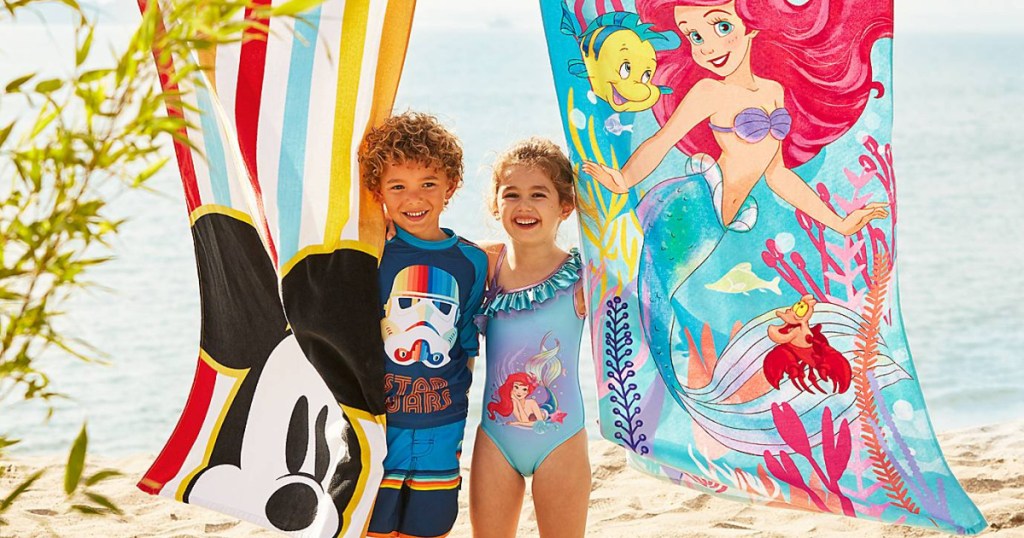 boy and girl with mickey and Ariel beach towels