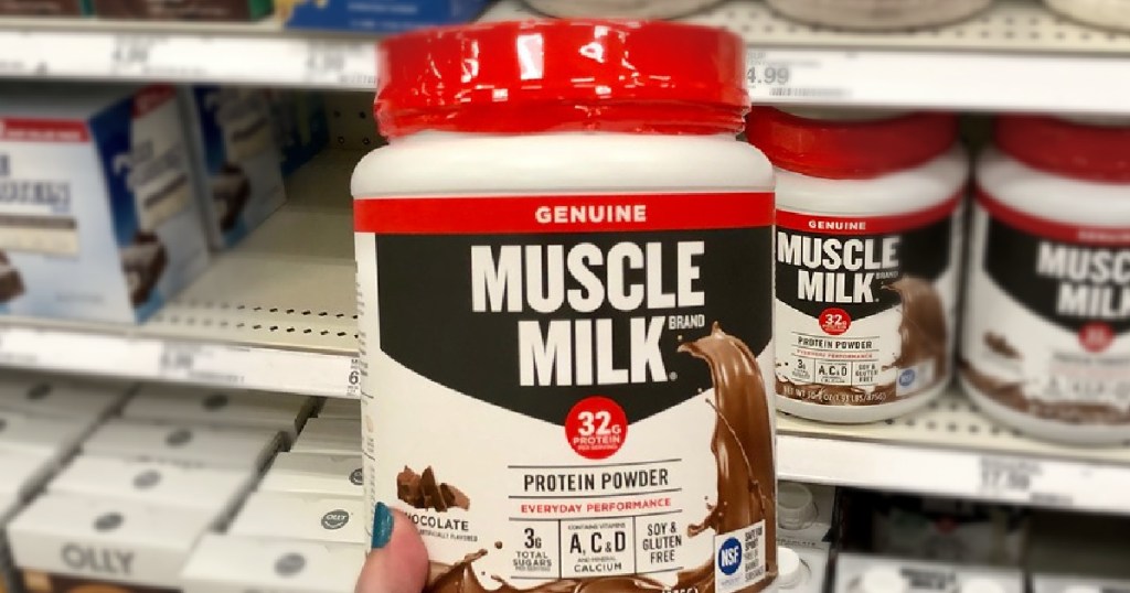 muscle mik protein powder in person's hand