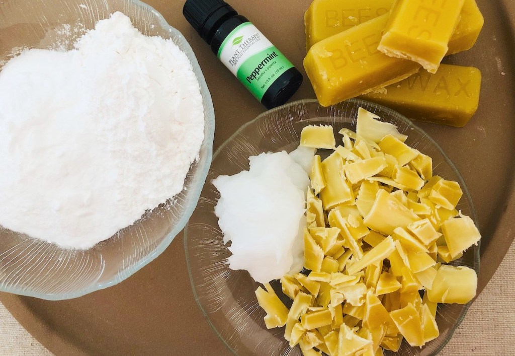 coconut oil, beeswax, essential oils, baking soda, and arrowroot powder on tray