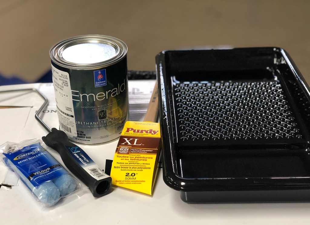 painting supplies with paint can from sherwin williams, paint brushes, and paint tray